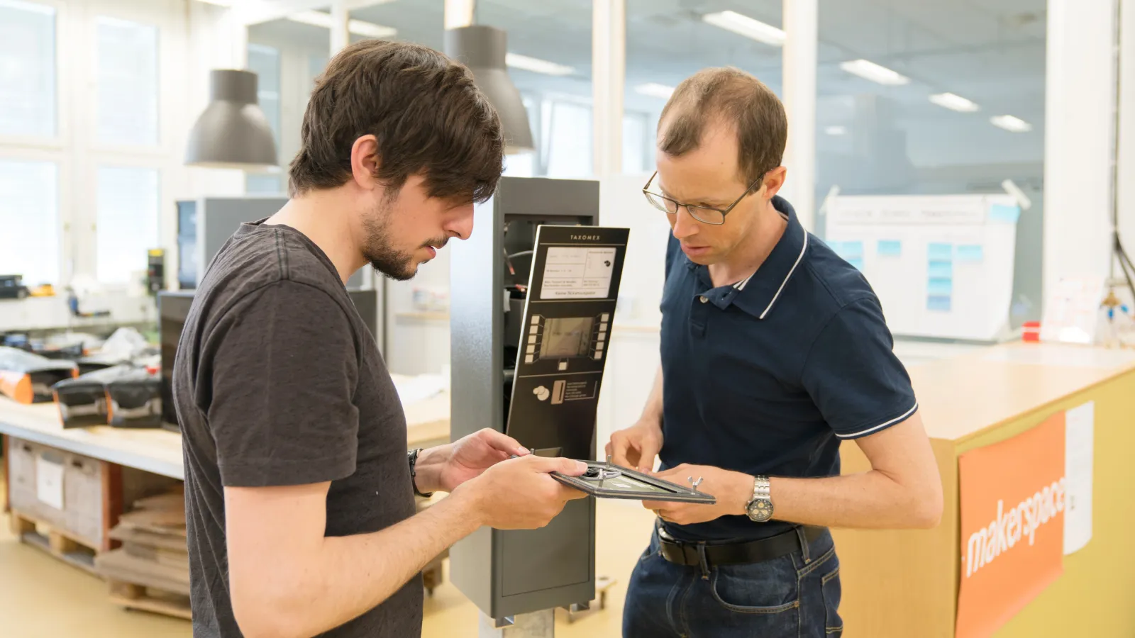 two systems engineers working on the taxomex park meter