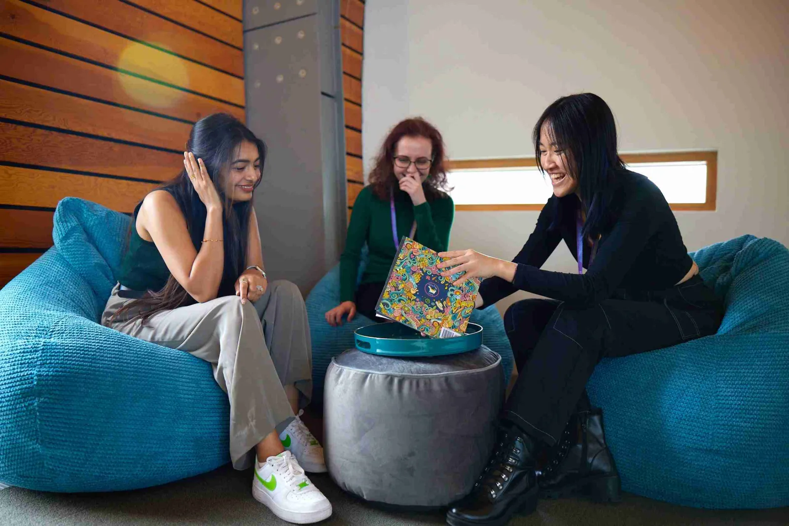 Women sitting on blue pouffs in Zühlke Manchester office quiet corner