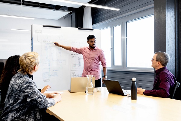 man explaining something on whiteboard