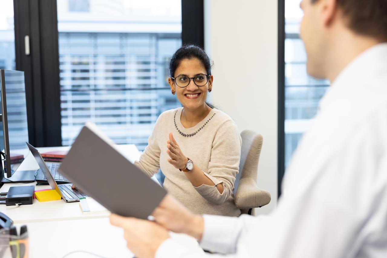 Colleague smiling at the desk at Zühlke office