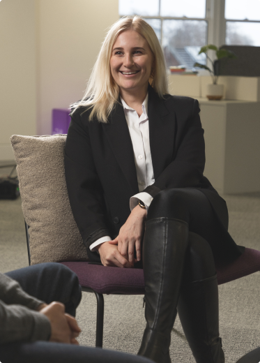 blonde woman sitting in a suit