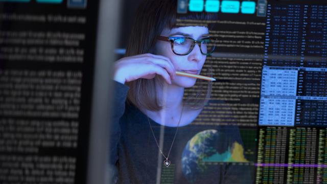 Woman looking over code