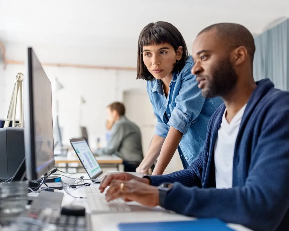 Two colleagues working at a desk