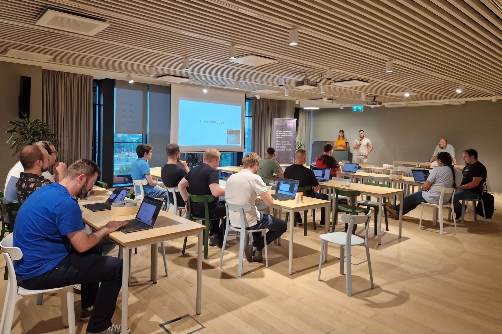 A group of people in a room with laptops