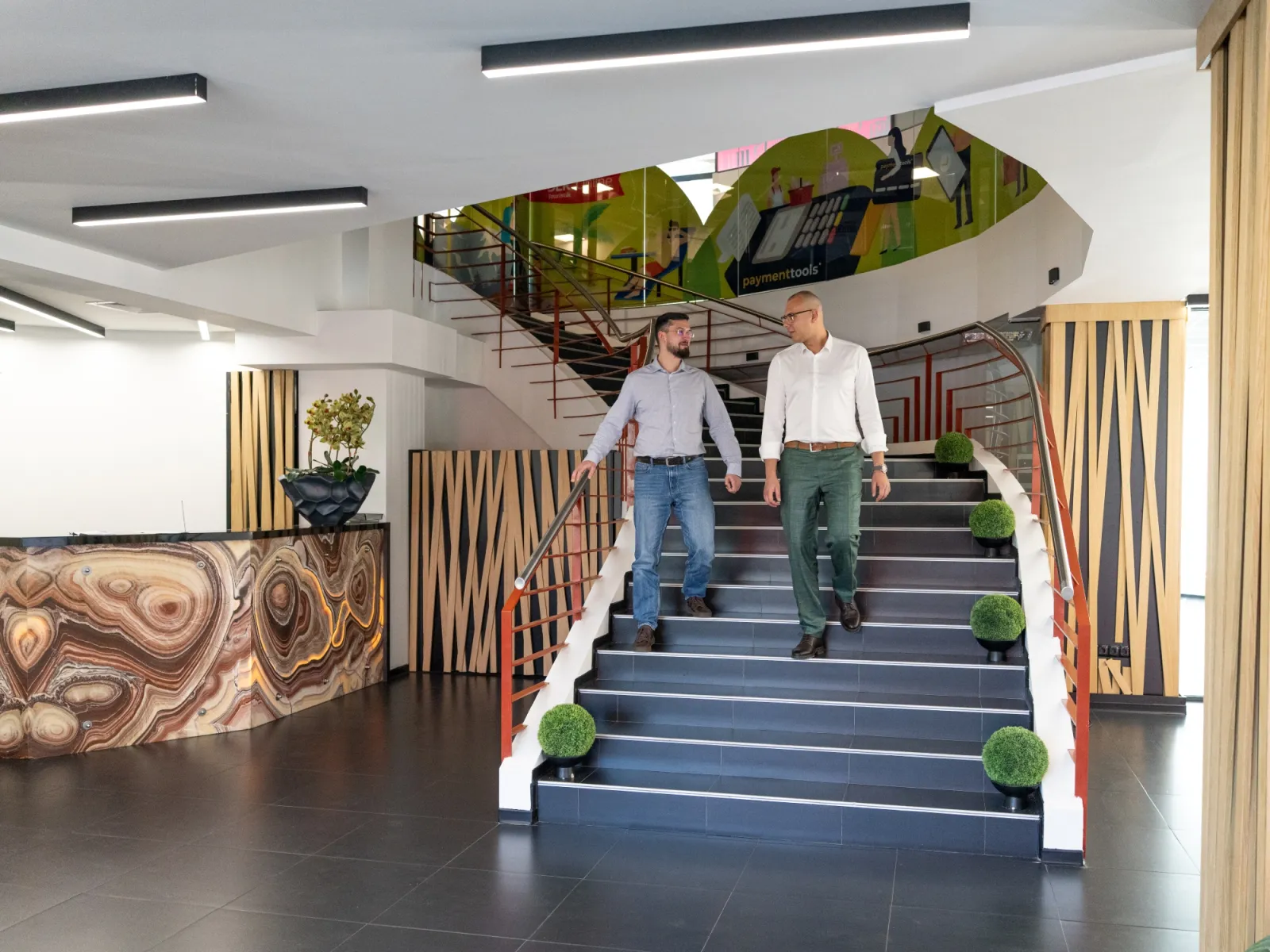 Two men walking up stairs in a building