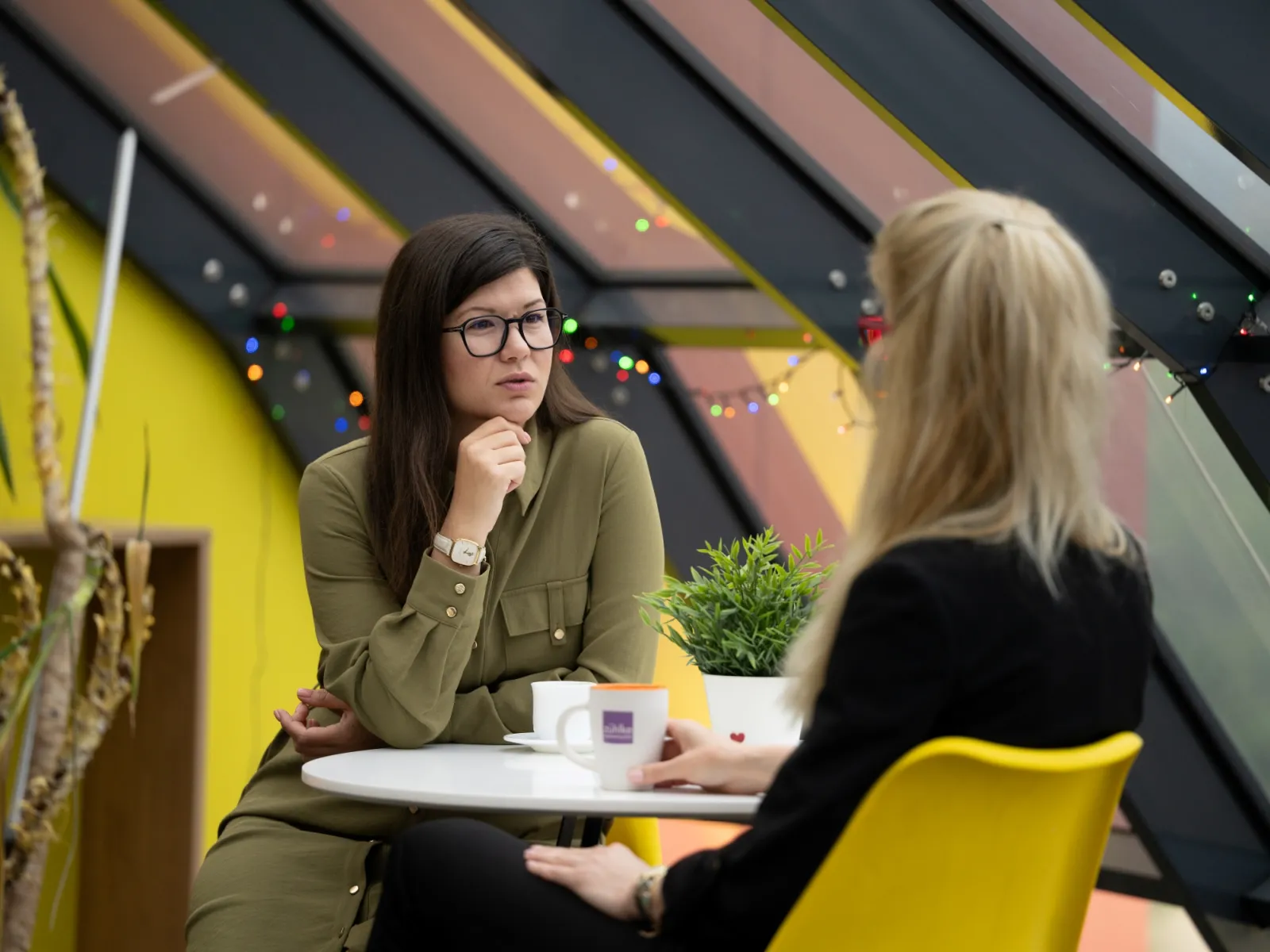 Two women sitting at a table and talking