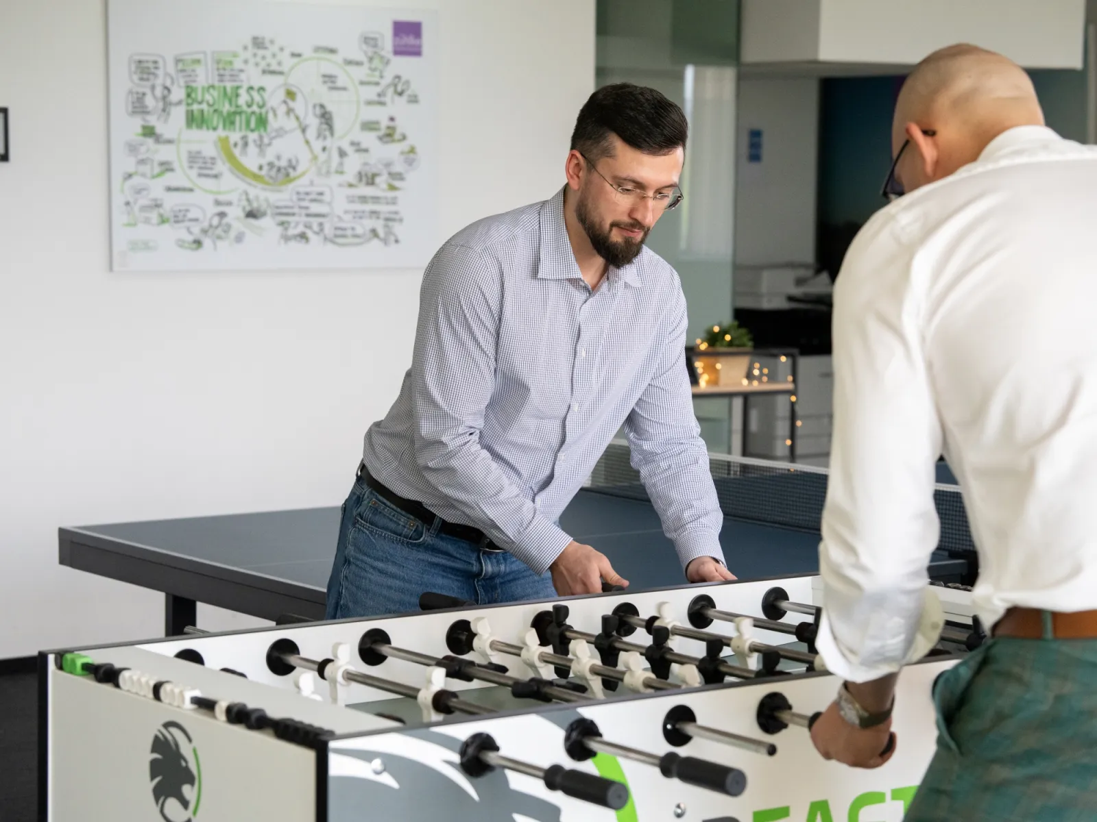 Men playing table football in a room