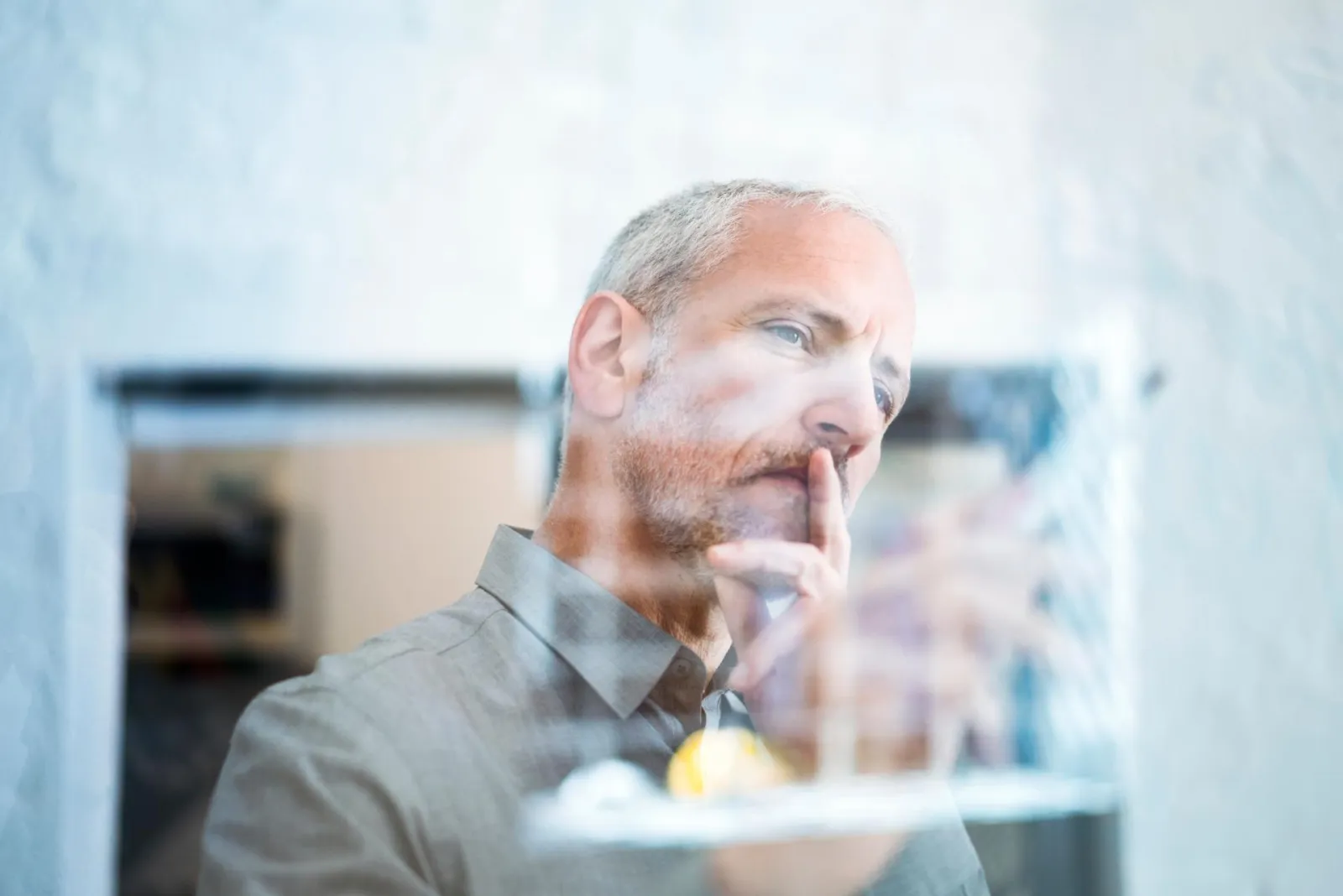 Business man drawing on a glass wall in a brainstorm