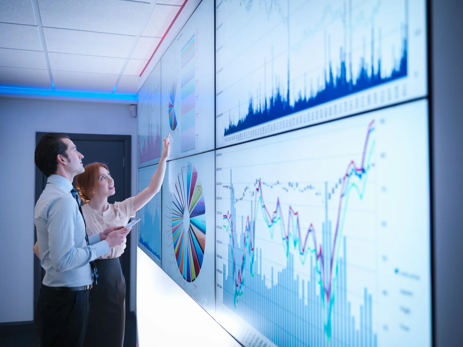 two employees working on a screen on data