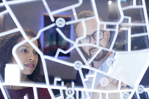 A woman and an man looking at a virtual screen