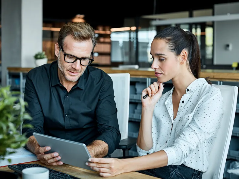 Two persons discussing about business innovation in the industries sector