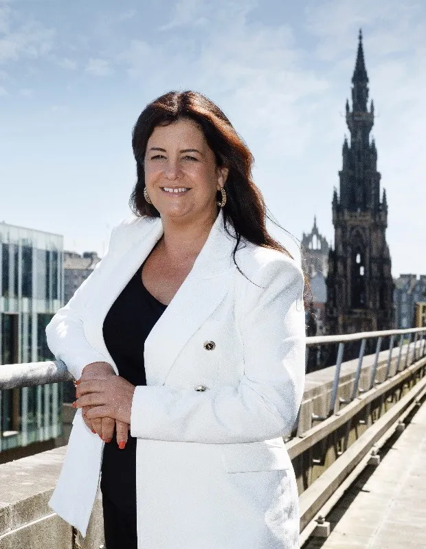 A woman standing on the balcony of the beautiful building in the centre of Edinburgh