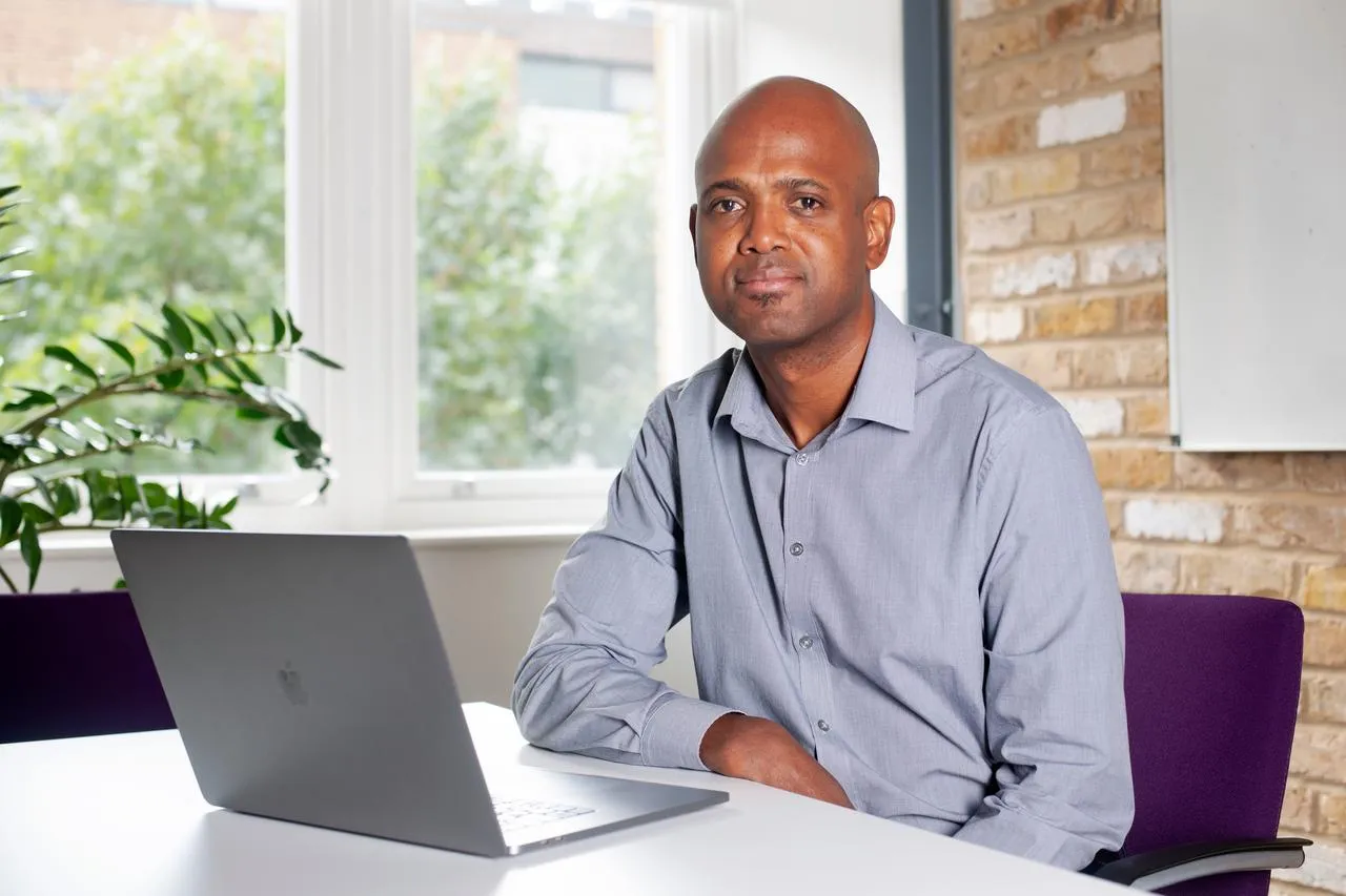 Man in Suit sitting on his laptop