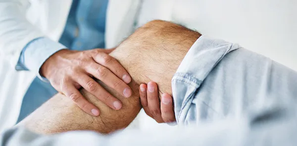 Doctor examining a patient's knee