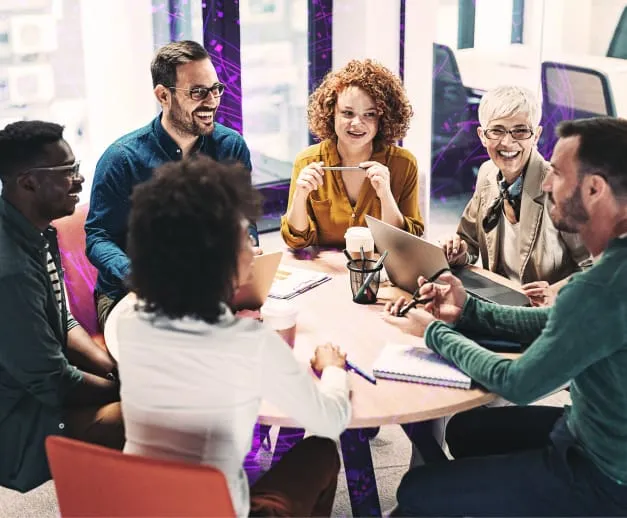 Group of business people sitting and talking around a table.