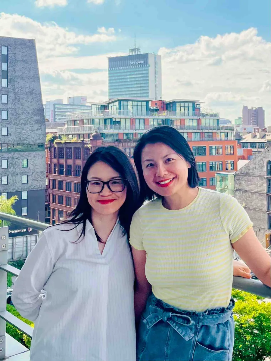 Shen and Li standing at the balcony in Zühlke Manchester office