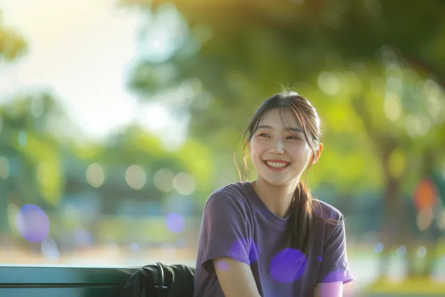 Young Asian woman in front of a green background