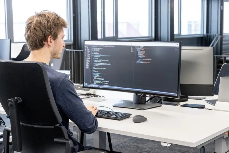 male individual working on a laptop